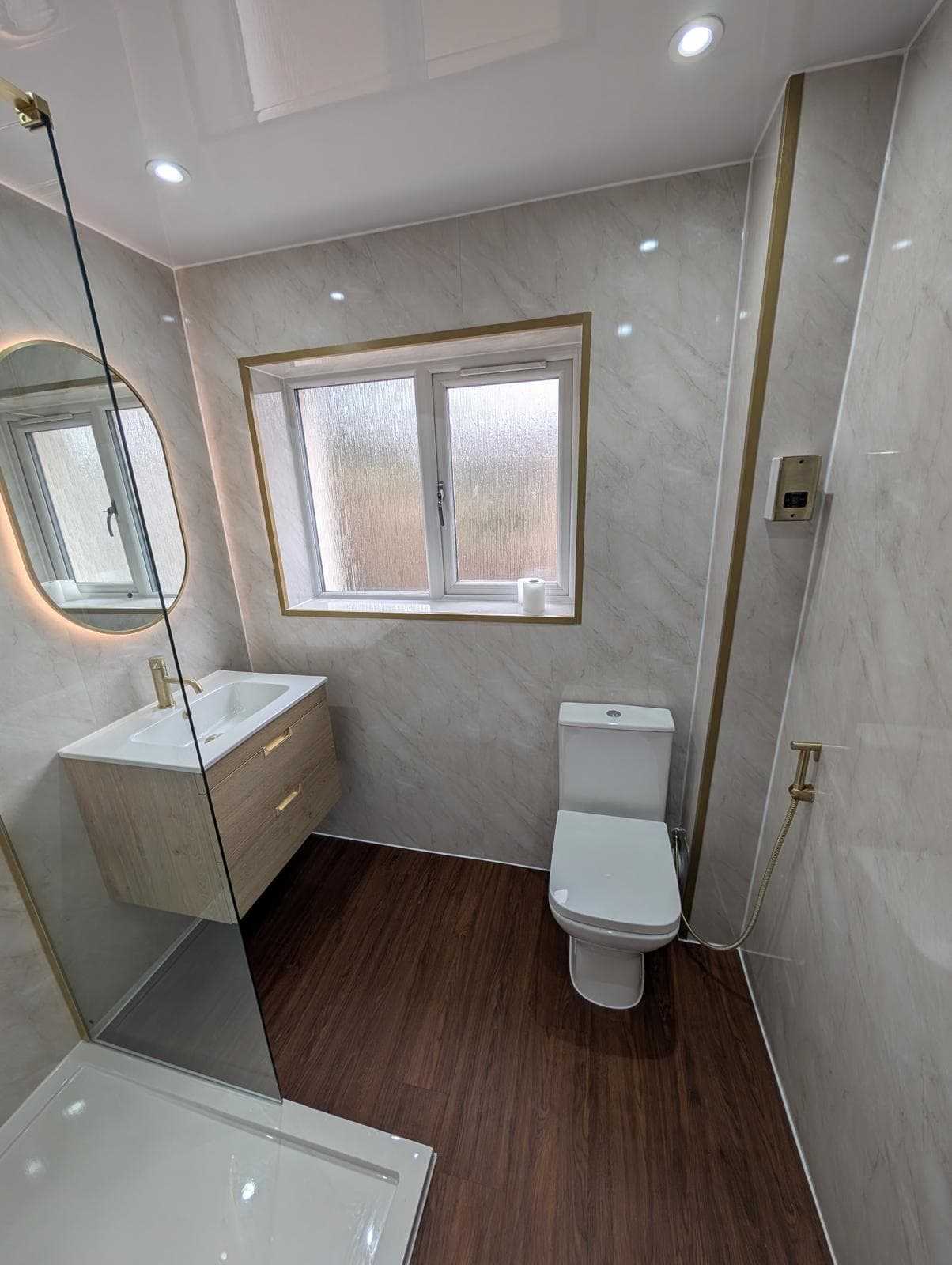 Marble-effect bathroom fitted in Fife with brushed brass fittings