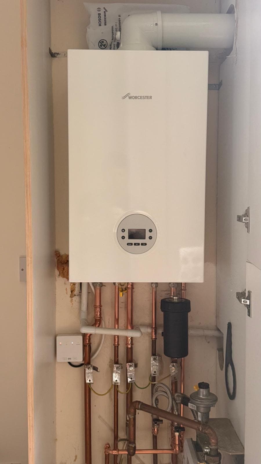 Worcester Bosch combi boiler installed in a cupboard with a magnetic filter and earth-bonded copper pipework, Livingston